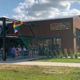 (Downtown, Des Moines, IA) Scooter’s 1352nd bar, first visited in 2019. There were a crap-ton of cyclists here. And, despite the rainbow banners outside, in one corner was a small...